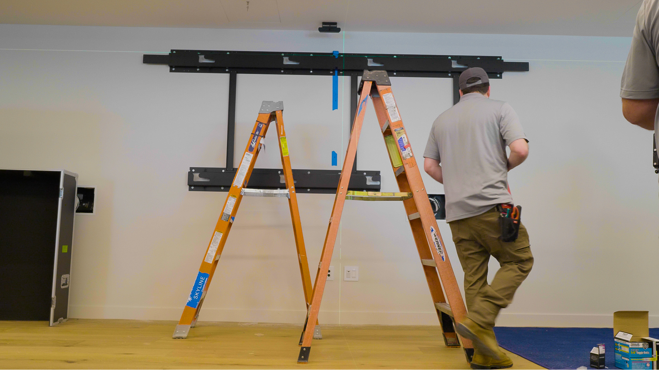 A AV technician installing a digital signage